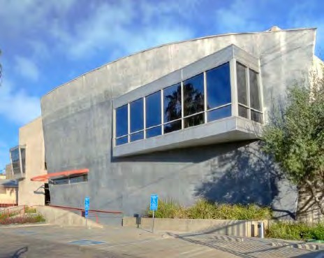 Exterior of Selma House showing the curved concrete volume and ribbon windows
