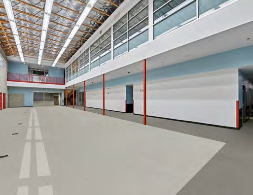 Upper-level open gallery space with skylights and exposed structure